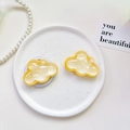Macro detail of cloud-shaped phone socket with glitter finish on a white tray - Pearlescent Cloud-Yellow
