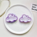 Macro shot of two light purple glitter cloud-shaped phone grips on a ceramic plate - Pearlescent Cloud-Purple