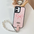 Detail of pink leather case with polka dot bow and white pearl beaded wrist strap - Pearlescent Polka Dot Bowknot (With Artificial Pearl Chain) / Pink / iPhone 16e