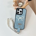 Detail of light blue pleated leather iPhone case with pearl strap and bow accessory - Blue / iPhone 16e