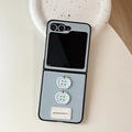 Detail of light blue lychee leather folding case with plaid apple charms and label - Leather Texture Light Blue / Samsung ZFold3