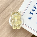 Macro shot of yellow glittery bear phone grip with sequins on light wood desk - Magnetic Glitter Bear / Yellow