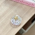 Detail of a round resin phone grip featuring a golden starfish and purple stones - Starry Sky Griptok Starfish Shell Stone / Purple