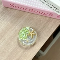 Detail of round ocean-style phone grip with resin starfish and green shells on wood - Starry Sky Griptok Starfish Shell Stone / Fruit Green