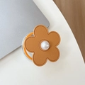 Macro detail of leather flower phone grip with pearl center on a minimalist desktop - Magnetic Small Pearl Leather Flower / Gold Brown