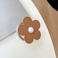 Detail of flower phone grip featuring brown leather petals and a center pearl inlay - Magnetic Small Pearl Leather Flower / Brown
