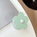 Detail of light green leather flower phone socket with center pearl on white desk - Magnetic Small Pearl Leather Flower / Green