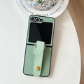 Detail of mint green lychee leather phone case with ring stand and gold hardware accents - Green / Samsung ZFlip3