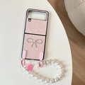 Close-up of pink pleated leather case for Samsung Galaxy Z Flip with rhinestone bow and pearls - Pearly Pink (With Bow Heart Chain) / Samsung Z Flip 3
