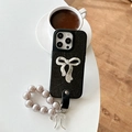Detail of black leather iPhone case with silver bow and lavender pearl wrist strap chain - iPhone X/XS / Black