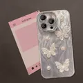 Macro shot of silver butterfly and pearl decorations on iPhone case with lens protection - Yusha Pearl Butterfly / iPhone 11