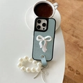 Detail of light blue faux leather iPhone case with large 3D bow and pearl wrist strap - iPhone X/XS / Blue