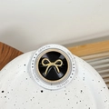 Macro view of magnetic phone socket featuring golden bow and Gift For You text design - Smooth Bow Tie (Black)