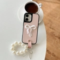 Close-up of pink wrinkled leather phone case with pearl chain and bow detail - iPhone X/XS / Pink