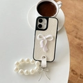 Detail of creamy white leather phone case with 3D bow and pearl chain strap - iPhone X/XS / White