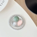 Detailed close-up of a luxury phone grip with green gemstone, pink crystal and pearls - Silver Series No. 7