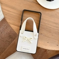 White leather folding phone case featuring a chic bow and a convenient hand strap detail - White / Samsung ZFlip3