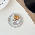Detailed close-up of a luxury phone socket with rhinestones, pearls and amber star inlay - Silver Series No. 12