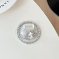 Detail of a luxury round phone grip featuring rhinestones, star, and cat eye stone - Silver Series No. 11