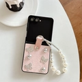 Detailed view of pink leather flip phone case with diamond butterflies and pearl strap - Pearlescent Pattern Butterfly Pearl Drill Chain-Pink / Samsung ZFlip3