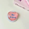 Detail of pink heart-shaped phone grip with 'Be brave' text on a minimalist desk - Magnetic-Crystal Glass Heart-Bean Paste Red
