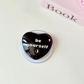 Close-up of black heart-shaped glass phone grip featuring Be Yourself text - Magnetic-Crystal Glass Heart-Black