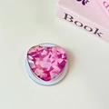 Draufsicht auf eine herzförmige Handy-Halterung mit geometrischem rosa Muster auf dem Tisch - Magnetisch-Kristallglas Herz-Rosarot Splitter