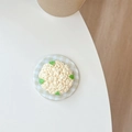 Macro shot of 3D cauliflower phone grip on green checkered base with detailed texture - Broccoli Style (Yellow)