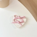 Dettaglio supporto telefono a cuore in pelle beige con fiocchi rosa e scritta - Rosa