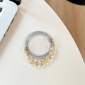 Close-up of silver glitter phone grip with amber faceted crystal beads decoration - Silver Glitter + Gold Crystal Chain