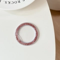 Macro shot of pink glitter phone camera lens protector ring on white desktop - Deep Pink