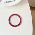 Macro view of red glitter circular magnetic phone grip base on a white surface - Rose Red