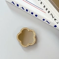 Detailed view of flower-shaped phone grip with sparkling rhinestones and a mirror surface - Flower-Gold