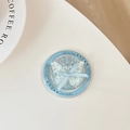 Close-up of circular blue sequin phone grip featuring a 3D butterfly and Gift For You text - Magnetic Gift Version - Polka Dot Glitter Glue Ribbon Bow Tie - Floral Blue