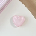 Detail of pink 3D heart phone grip with pearl luster finish on a minimal white desk - Matte Heart Holder-Cloud Glitter Pink