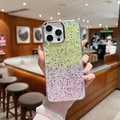 Detail showing gradient glitter phone case with fine gold powder for iPhone 16 Pro Max - Yellow+Pink (Electroplated Frame High Flash Sequin Gradient) / iPhone 16e