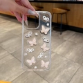 Detail of transparent phone case featuring 3D pearl bows and shimmering butterflies - iPhone 7/8/SE 2020 / Orange Butterfly (Pearl Bowtie Glitter)