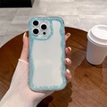 Detailed view of wave-shaped glitter phone case for iPhone on a cozy desk - Blue Glitter Edge / iPhone 16e
