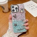 Detail of glitter gradient iPhone case featuring 3D pearl bear and metal flower charms - Pink + Blue / iPhone 7/8/SE 2020