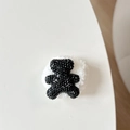 Macro detail of plush teddy bear phone grip with sparkling black rhinestones and bow tie - Plush Rhinestone Bear Shape / Black