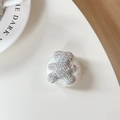 Macro view of plush teddy bear phone grip featuring sparkling AB rhinestones - Plush Rhinestone Bear Shape / Iridescent