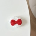 Close-up of white plush bear phone grip with sparkling red rhinestone butterfly bow detail - Plush Rhinestone Round Bowknot Shape / Red
