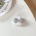 Detail showing plush lamb wool phone grip base with sparkling rhinestone metal bow - Plush Rhinestone Round Bowknot Shape / Iridescent