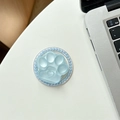 Detail of light blue matte cat paw phone grip with faux pearl beaded trim on white desk - Shimmering Blue