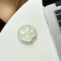 Detail view of cat paw phone grip with heart center and green pearls on silver laptop - Shimmering Light Green