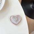 Detailed view of a 3D heart-shaped phone socket featuring a metallic letter emblem - Brown Glitter