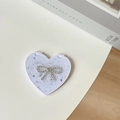 Macro view of heart-shaped portable mirror with sparkling glitter and rhinestone bow decoration - Starry Silver Foil Bow #3 / White