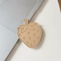 Close-up of strawberry shaped beige lychee leather phone socket with fine stitching details - Khaki
