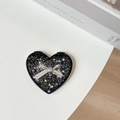 Macro shot of heart-shaped folding mirror with black sequins and a metal bow decoration - Starry Silver Foil Bow #7 / Black
