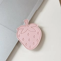 Close-up of strawberry-shaped pink PU leather phone socket with 3D embossed texture - Light Pink
